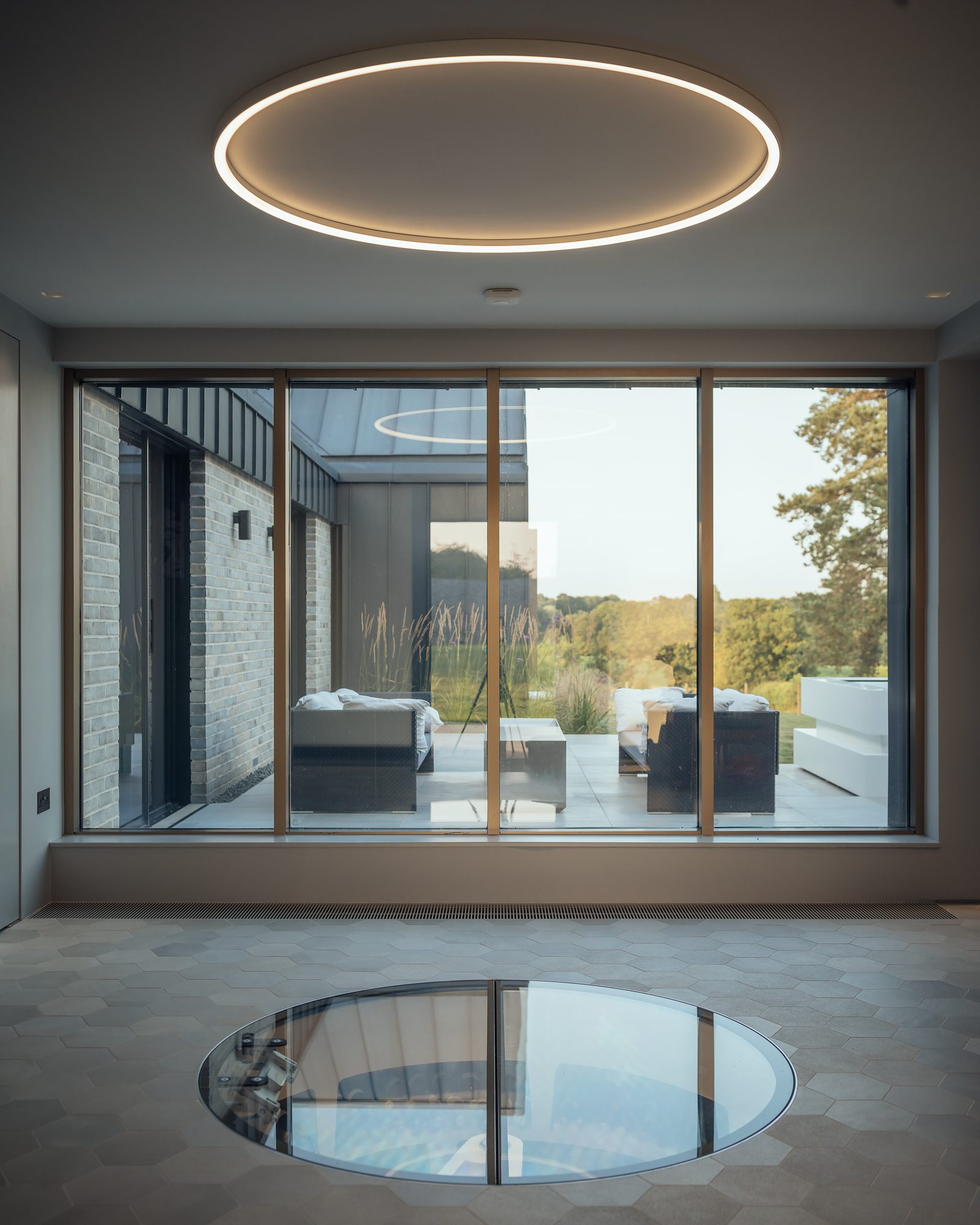 Living space at Eastwood Farm with a circular rooflight above a circular floor light